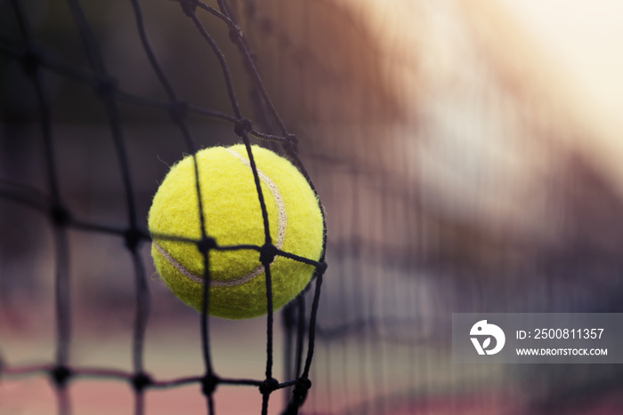 Tennis ball hitting the tennis net at tennis court with copy space.