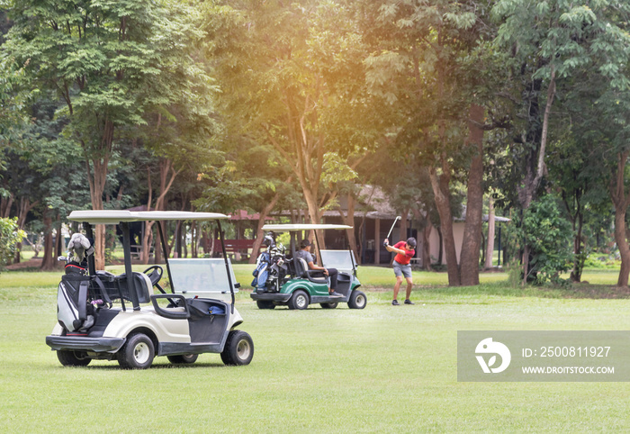 Golf carts parked on green fairway at golf course