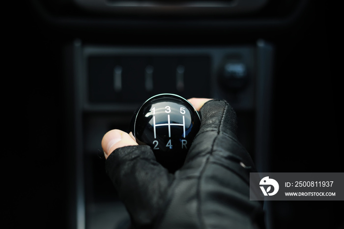 Gear lever. Manual Transmission. Hand on the gear shift in a car.