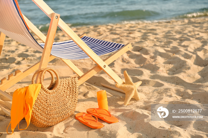 Chair with bag and accessories on sand beach