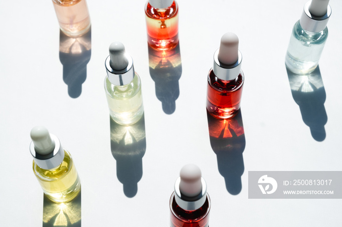 Dropper glass bottles with pipette. Transparent hyaluronic natural beauty mineral product and eco serum skin care concept. Top horizontal view copyspace. Summer juicy colors