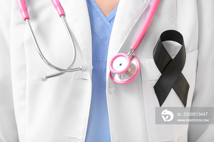 Doctor with black ribbon and stethoscope, closeup. Melanoma concept