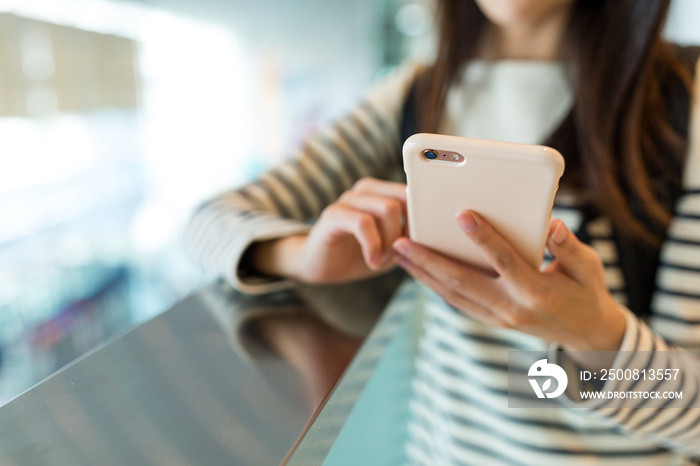 Woman use of mobile phone in shopping mall