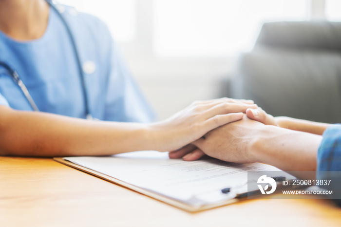 Doctor and patient shaking hands in office, they are sitting at desk, discussing something ,Having Consultation,Medical physician working in hospital writing a prescription, medically  Healthcare