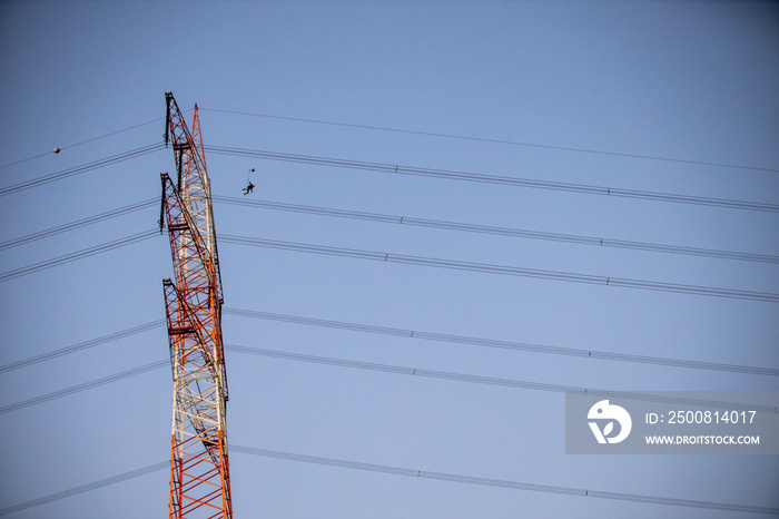 Man BASE jumping from antenna in the evening with full moon