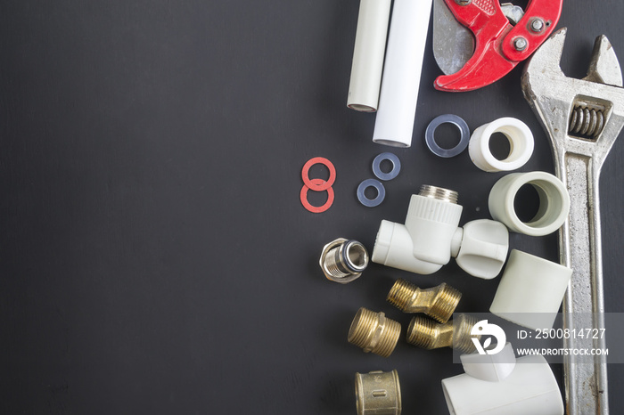 Tools for repair of water supply systems on a black background.