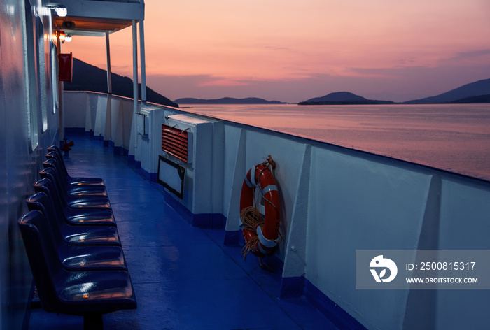 Ferry boat deck without people at sunset, view at the sea