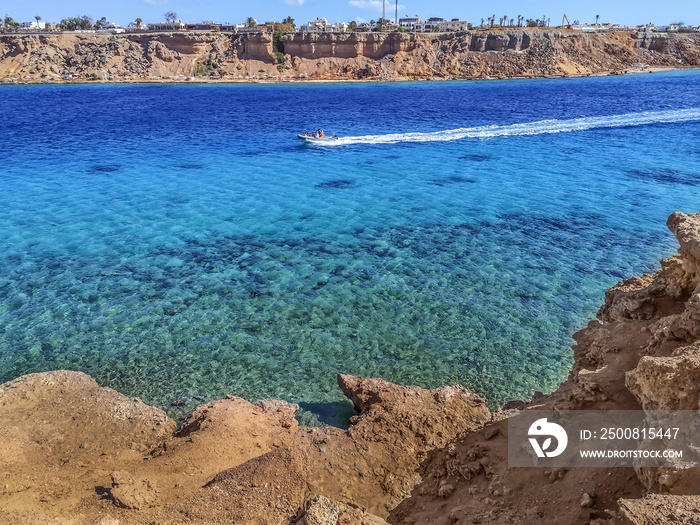 The boat sails on the Red Sea in the Sharm el-Maya bay in Sharm El Sheikh, Egypt. Amazing seascape in the Sinai Peninsula