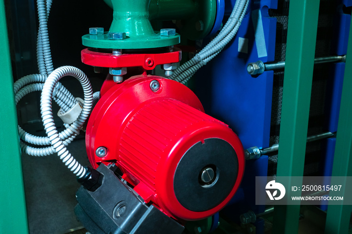 Circulation pump for heating systems. Red circulation pump close up. Concept - sale of a pump for heating systems. Electrical equipment for heating systems. House preheating equipment.