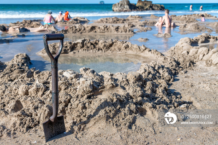 Making your own pool in Hot Water Beach, Coromandel, New Zealand