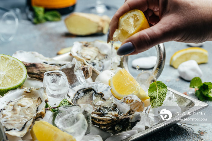 Fresh oysters with lime on a round plate. seafood dish. Oyster on the half shell. Restaurant menu, dieting, cookbook recipe