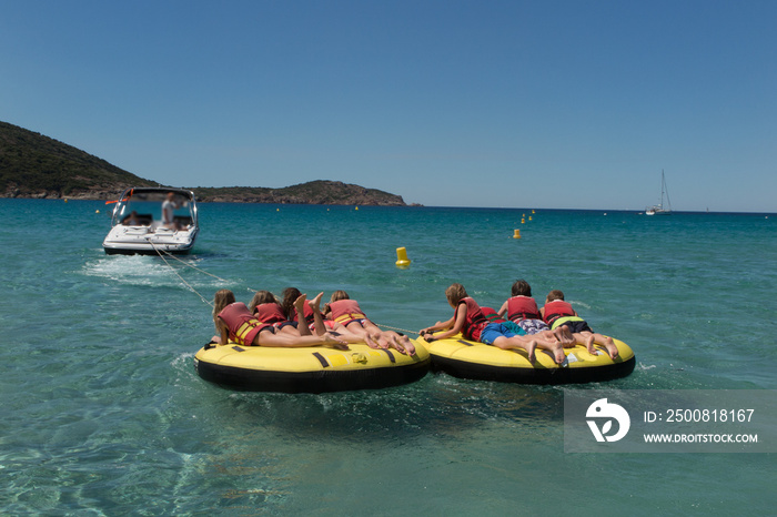 Kids towed together in a watersport buoy