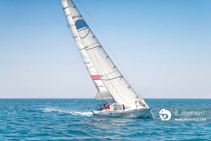 Sailing keelboat yacht with white sails