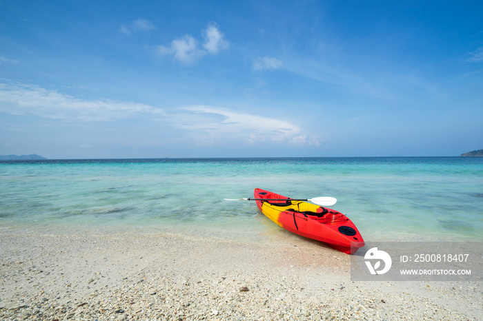 Colorful kayak on the tropical beach with blue sky