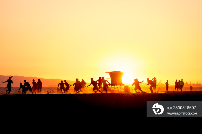 Group of people playing flag football in the summer sunset