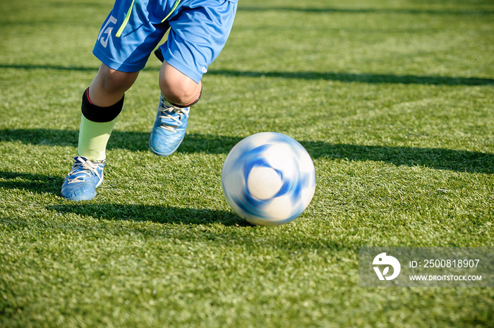 Youth Football Training on Sports Field. Young Boys Running and Kicking Soccer Ball.