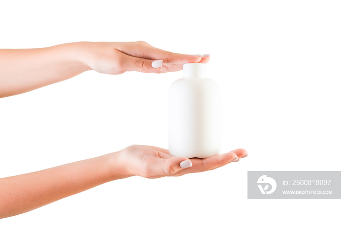 Female hand holding cream bottle of lotion isolated. Girl give tube cosmetic products on white background