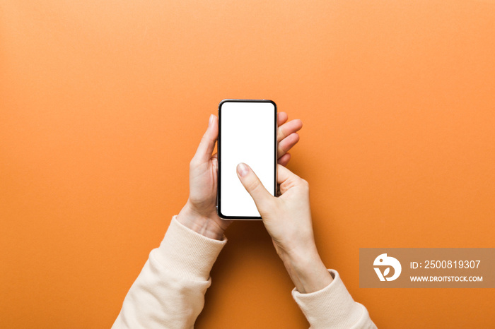 Top view of woman hands holding smart phone with blank copy space screen for your text message or information content. woman hand using phone white screen on top view