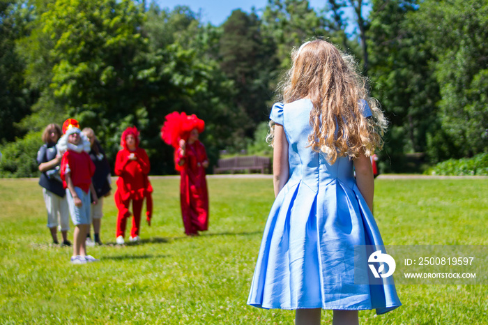 Alice in wonderland staging scene in outdoor park theater.