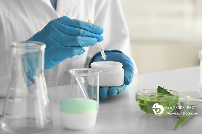 Woman making organic cosmetics with aloe in laboratory