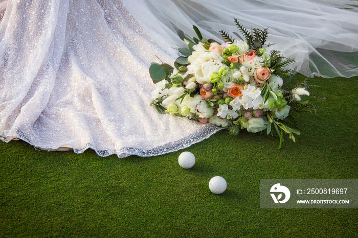 wedding bouquet near of bride dress on the golf field. macro flowers with golf balls near stylish dress on the grass. wedding concept