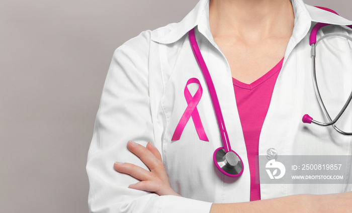 Female doctor with pink ribbon. Cancer concept