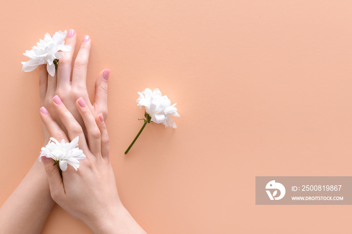 Female hands with fresh flowers on color background