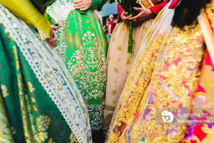 Detail of the traditional Spanish Valencian Fallera dress, colorful fabrics with intricate embroidery.