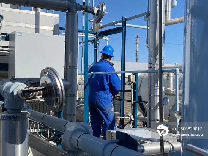 Industrial workers checking the temperatures at a LNG plant