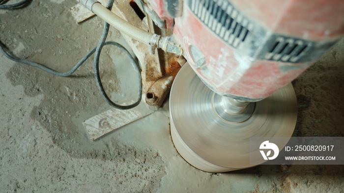 Powerful power tool drills a hole in a concrete ceiling