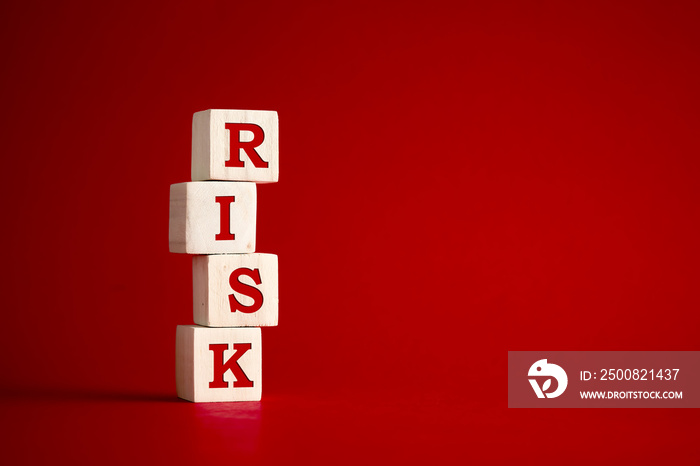 The word risk on wooden cubes. Risk and uncertainty in business and decision making strategy concept.