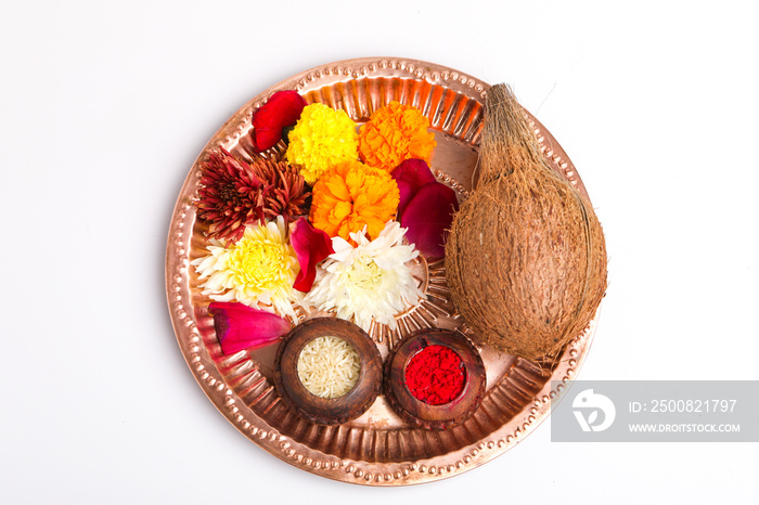 Beautifully Decorated Pooja Thali for festival celebration to worship, rice grain and kumkum, flowers, hindu puja thali.