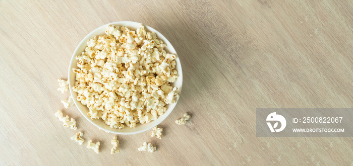 popcorn on the wooden table. flat lay of popcorn in bowl. top view. copy space for text