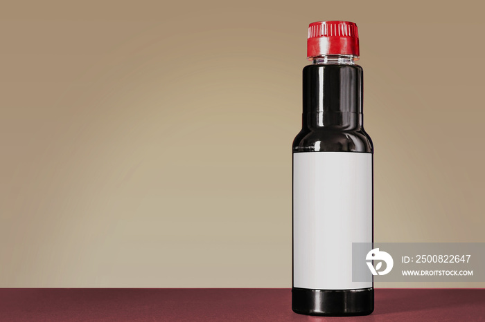 soy sauce bottle mock up standing on a black table against the purple background with copy space