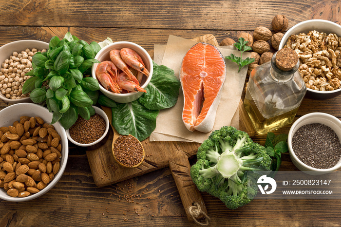 Set of food for healthy nutrition on a wooden background top view. Food sources of omega 3 and omega 6