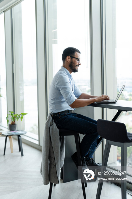 Businessman with laptop working in modern office