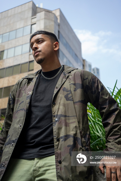 Young man wearing black tshirt and camouflage jacket