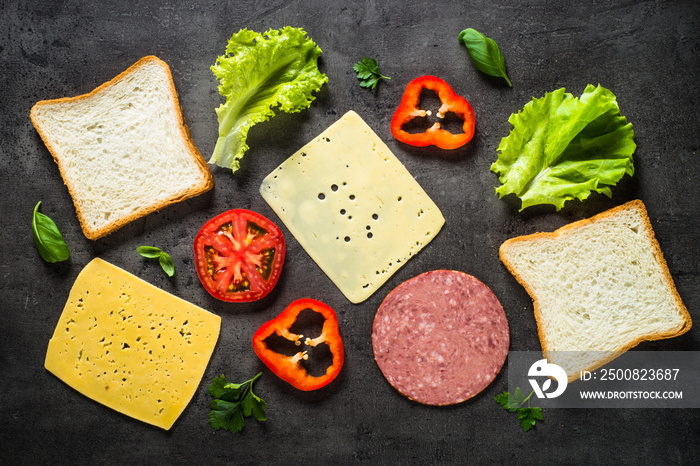 Ingredients for sandwich on a black background.