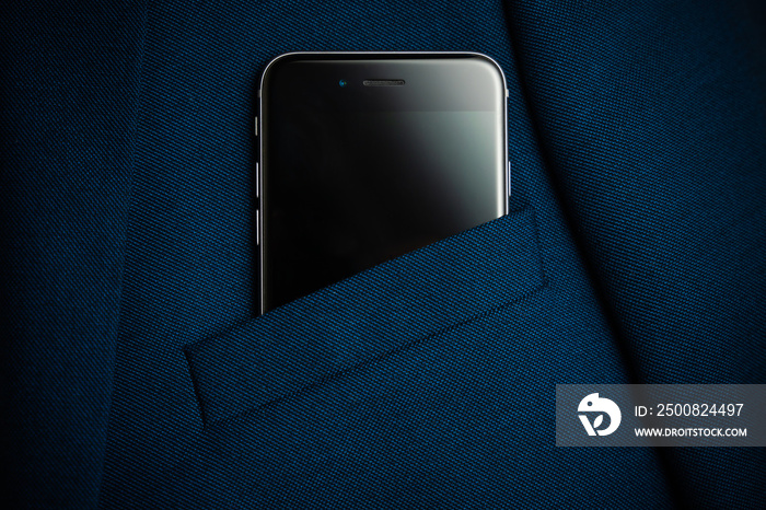 Black smartphone in men suit pocket close up.