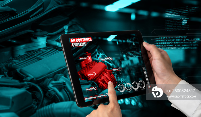 Engineer use augmented reality software to monitor parts of car vehicle with automated application . Futuristic machinery in working in concept of Industry 4.0 or 4th industrial revolution.