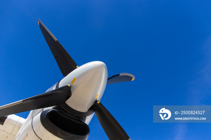 bottom view of aircraft propeller blade and turboprop engines with blue sky background