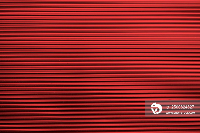 Metal corrugated background with free space for text. Red wavy grooved metal texture, copy space