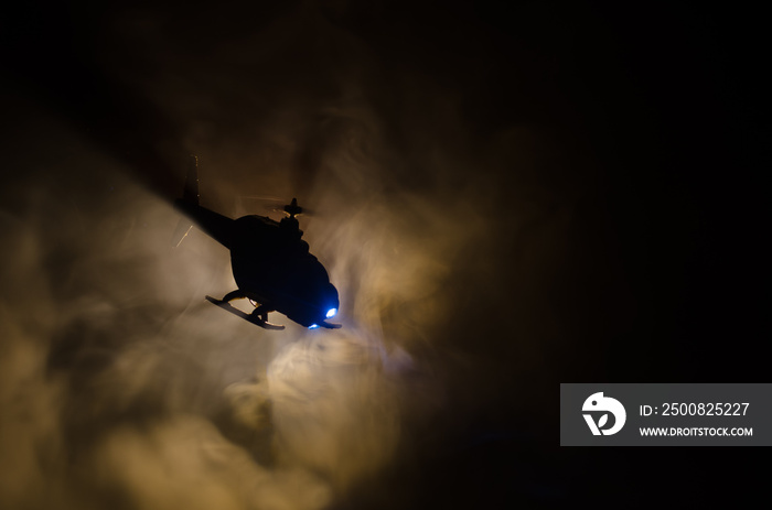 Helicopter over fire sunset horizon. War concept. Military scene of flying helicopter fire backgroung effect. Decoration