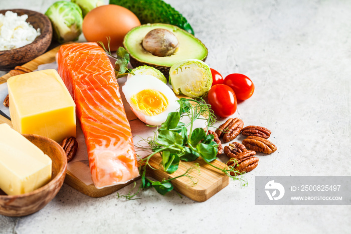 Balanced diet food concept. Fish, eggs, cheese, nuts, butter and vegetables - balanced food.