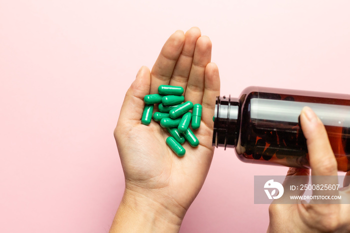 Rhodiola rosea capsules poured on the hand from the package.