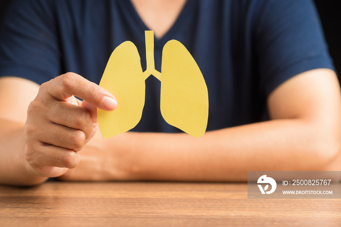 Close-up of hand a man holding lungs symbol while sitting in the hospital