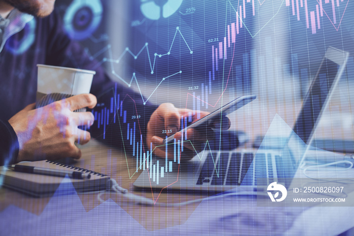 Double exposure of man’s hands holding and using a phone and financial graph drawing. Analysis concept.