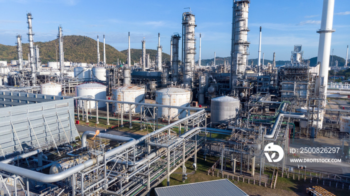 Aerial view of chemical oil refinery plant, power plant on blue sky background.