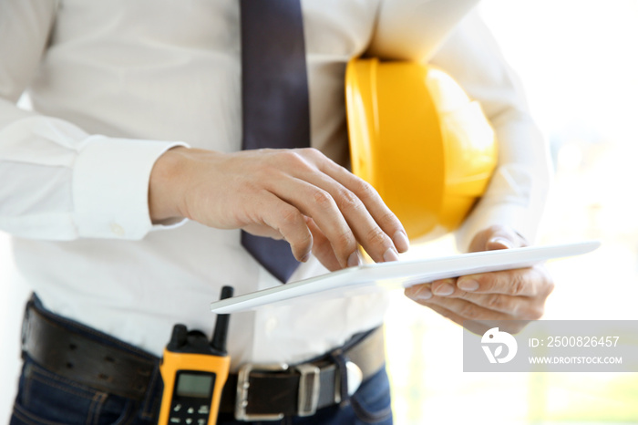 Engineer with tablet computer in office, closeup