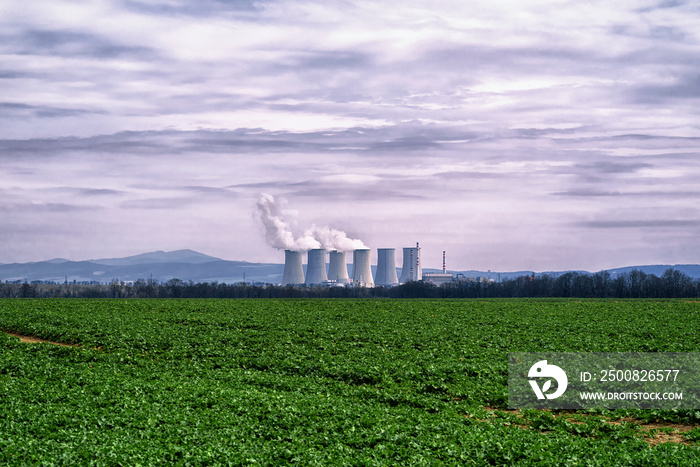 Power station,coal fired power station with cooling towers releasing steam into atmosphere.Power plant against the dark sky.